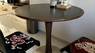 The Round Dining Table: Where Sintered Stone Elegance Meets Walnut Warmth