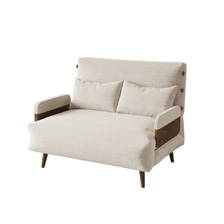 A beige linen convertible loveseat features dark wood armrests, tapered legs, and button-tufted side details against a clean white background. Two matching rectangular lumbar pillows rest neatly against its supportive backrest. This versatile piece combines a cozy modern aesthetic with functional design.
