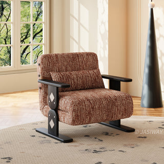 A modern brown textured armchair sits centered on a patterned area rug in a sunlit room. The chair features distinct dark wooden legs and flat armrests with decorative diamond inlay accents on the side supports. A matching elongated lumbar pillow rests against its cushioned backrest. In the background, a large window reveals green foliage alongside a unique dark cone-shaped floor lamp.