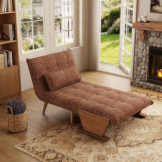 A modern convertible chaise lounge upholstered in textured brown fabric is set up as a recliner on a patterned area rug over a wooden floor. The lounge features an adjustable backrest with button-tufting, a matching rectangular bolster pillow, and wooden side supports combined with tapered wooden legs.