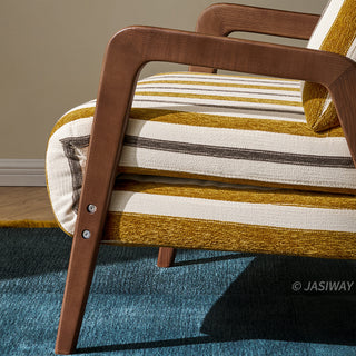 A close-up shot focuses on the sturdy dark wooden leg and frame structure of a yellow-and-white striped convertible armchair. Visible metal screws secure the angled wooden armrest to the main frame of the chair. The textured fabric upholstery displays clear stripes, while the chair rests on a deep blue carpet.