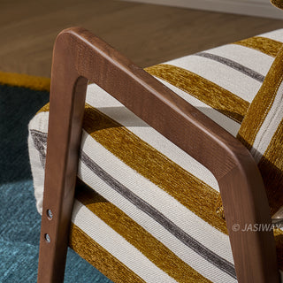 A close-up shot focuses on the smooth, polished dark wooden armrest of a yellow-and-white striped convertible armchair. The curved arm frame showcases natural wood grain textures alongside secure screw fixings near the base. The textured striped upholstery of the chair seat and a matching pillow are partially visible in the background.
