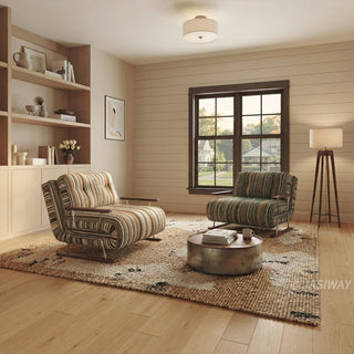 A spacious living room features two convertible armchairs—one upholstered in warm striped fabric and the other in olive green—placed on a large, textured area rug over a wooden floor. The space is decorated with built-in wooden shelving, a round metallic coffee table, a window with natural daylight, and a standing floor lamp. The warm, inviting arrangement highlights how multiple colorways of the convertible furniture can complement each other in a shared room layout.