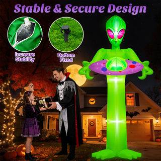 Stable and secure design features guide graphic for a giant Halloween inflatable green alien holding a UFO spaceship yard decoration, highlighting built-in water bags for stability, bottom ground fixed stakes, and family-friendly nighttime holiday display scenes on a suburban front lawn.