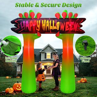 Stable and secure design feature graphic for a giant Halloween inflatable arch yard decoration featuring green zombie hands and a "Happy Halloween" sign, highlighting water bags for increased stability and bottom-fixed ground stakes for secure outdoor installation.
