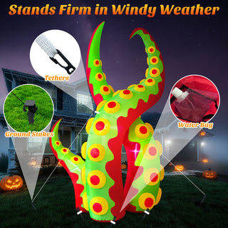 Stability feature guide graphic for a giant Halloween inflatable green and red monster tentacle yard decoration, demonstrating wind-resistant installation with tethers, ground stakes, and water bags for secure outdoor placement.