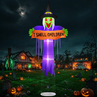 Giant Halloween inflatable floating witch yard decoration featuring a green face, a black witch hat, a purple robe, and an orange banner with the text "I Smell Children" displayed over a spooky nighttime graveyard and haunted house lawn.