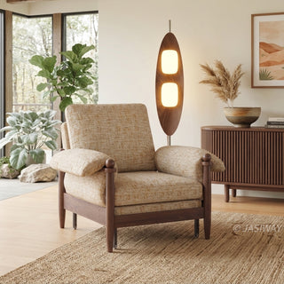Lifestyle staging shot of a beige accent armchair featuring dark wood framing and plush cushions in a warm, plant-filled living room.