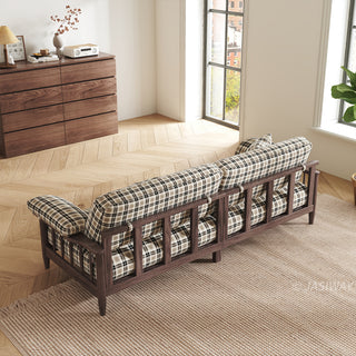 Back view of a plaid fabric sofa with dark wood spindle frame in a mid-century modern living room