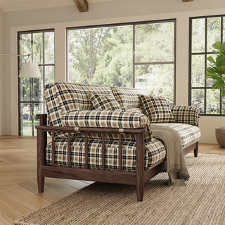 Modern farmhouse sofa with plaid upholstery and dark walnut wooden frame in a sunlit living room