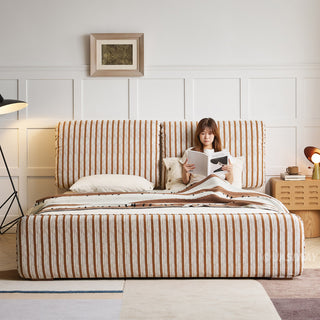 JASIWAY modern luxury upholstered platform bed frame featuring a curved wingback shelter headboard and premium textured chenille fabric upholstery in a neutral, multi-toned weave, available in queen and king sizes for high-end contemporary bedroom interiors.-Front view with model reading