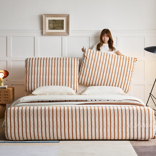 JASIWAY modern luxury upholstered platform bed frame featuring a curved wingback shelter headboard and premium textured chenille fabric upholstery in a neutral, multi-toned weave, available in queen and king sizes for high-end contemporary bedroom interiors.-Front view with model adjusting the headboard