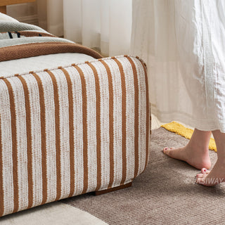 JASIWAY modern luxury upholstered platform bed frame featuring a curved wingback shelter headboard and premium textured chenille fabric upholstery in a neutral, multi-toned weave, available in queen and king sizes for high-end contemporary bedroom interiors.-Close-up of footboard corner