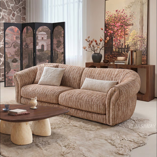 JASIWAY luxury curved chenille sofa featuring a structural biomorphic design, deep seat cushions, and premium textured multi-tonal chenille upholstery. This modern cloud couch showcases tailored rolled arms with integrated piping details and an organic, gently arched back silhouette.-Three quarter view