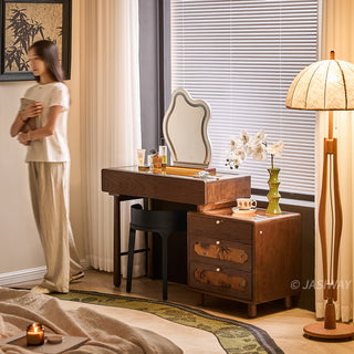 JASIWAY solid wood extendable vanity desk featuring a rich walnut-grain finish, a three-drawer side storage cabinet ,and a decorative tempered glass top, specifically engineered for luxury small-space interiors.-Three-quarter lifestyle view