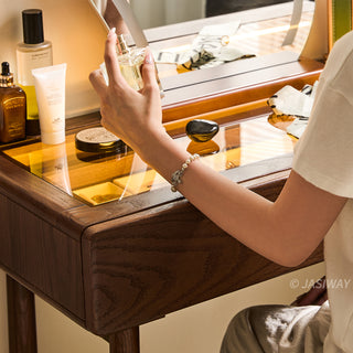 JASIWAY solid wood extendable vanity desk featuring a rich walnut-grain finish, a three-drawer side storage cabinet ,and a decorative tempered glass top, specifically engineered for luxury small-space interiors.-Close-up of tabletop