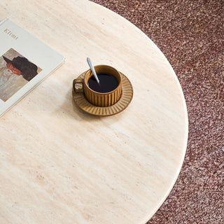 JASIWAY mid-century modern round coffee table featuring a polished beige faux marble top and a 2-tier functional design with a walnut-finished solid wood storage shelf and base.-Close-up of top material