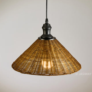 This is a close-up shot of a rustic pendant light fixture featuring a conical, woven rattan shade. The natural-toned wicker shade is suspended by a simple black fixture and cord against a plain, light grey background. A warm, glowing light is visible through the woven texture, creating an inviting ambiance.