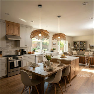 A bright, open-concept kitchen features two elegant, tiered woven pendant lights hanging over a wooden dining table. The space combines light grey cabinetry with warm wood accents, creating a modern yet cozy aesthetic. In the background, a comfortable living area with a sofa and bookshelf completes the welcoming, sunlit home environment.