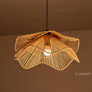 This pendant light features a sculptural, double-layered shade hand-crafted from natural fiber rope in a warm, earthy tone. Its flowing, wave-like silhouette creates a sophisticated organic aesthetic that adds textural depth to any space. The intricate rope detailing casts soft, inviting illumination, perfect for a curated, modern interior.