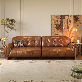 JASIWAY mid-century modern 3-seater sofa in rich vintage brown leather, featuring deep-seated cushions with classic tufted backrest detailing, thick rolled arms accented by sleek vertical metal legs, and an elegant low-profile silhouette designed for high-end residential interiors.-Front view