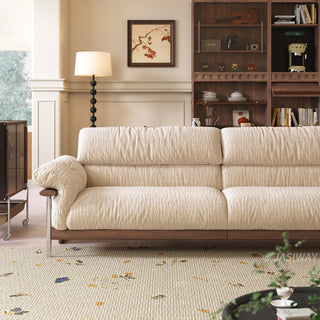 JASIWAY mid-century modern 3-seater sofa featuring textured chenille upholstery, sculptural curved armrests with integrated solid wood supports, and a low-profile exposed timber base frame accented by slender polished metal legs.-Medium shot