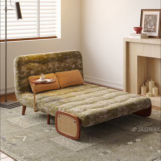 JASIWAY mid-century modern convertible sleeper chair bed upholstered in premium botanical jacquard fabric with olive green palm leaf patterns. Features a space-saving multi-functional design with an integrated swivel wooden side table, woven rattan armrest details, solid wood tapered legs, and a textured mustard lumbar support pillow. Ideal luxury accent sleeper lounger for high-end apartment living and compact spaces.-Three quarter view with chaise mode