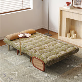 JASIWAY mid-century modern convertible sleeper chair bed upholstered in premium botanical jacquard fabric with olive green palm leaf patterns. Features a space-saving multi-functional design with an integrated swivel wooden side table, woven rattan armrest details, solid wood tapered legs, and a textured mustard lumbar support pillow. Ideal luxury accent sleeper lounger for high-end apartment living and compact spaces.-High-angle view with bed mode