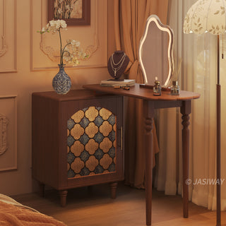 Mid-century modern solid wood makeup vanity table featuring an extendable desktop and integrated storage chest with decorative glass door, complemented by tapered legs and a space-saving telescopic configuration suitable for versatile bedroom storage.-Three-quarter view of warm lighting