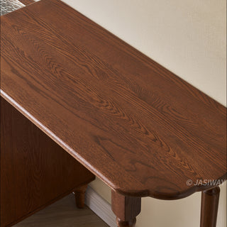Mid-century modern solid wood makeup vanity table featuring an extendable desktop and integrated storage chest with decorative glass door, complemented by tapered legs and a space-saving telescopic configuration suitable for versatile bedroom storage.-Close-up of material texture