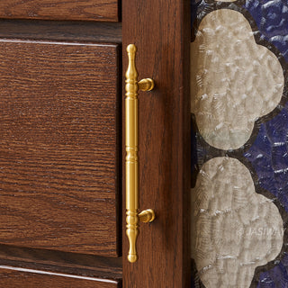 Mid-century modern solid wood makeup vanity table featuring an extendable desktop and integrated storage chest with decorative glass door, complemented by tapered legs and a space-saving telescopic configuration suitable for versatile bedroom storage.-Close-up of door handle