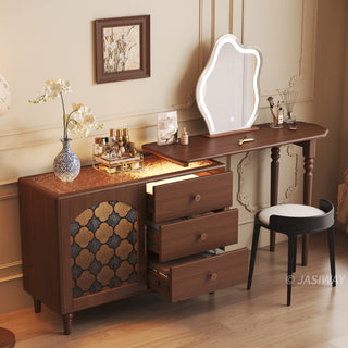 Mid-century modern solid wood makeup vanity table featuring an extendable desktop and integrated storage chest with decorative glass door, complemented by tapered legs and a space-saving telescopic configuration suitable for versatile bedroom storage.-High-angle three-quarter view