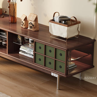 JASIWAY mid-century modern TV stand featuring a rich walnut and boxwood finish, sliding cabinet doors with olive green grid accents, and open tempered glass shelving, blending organic retro aesthetics with functional storage for upscale living room entertainment centers.-Three-quarter medium shot