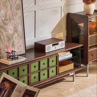 JASIWAY mid-century modern TV stand featuring a rich walnut and boxwood finish, sliding cabinet doors with olive green grid accents, and open tempered glass shelving, blending organic retro aesthetics with functional storage for upscale living room entertainment centers.-High-angle medium shot