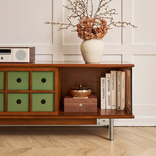 JASIWAY mid-century modern TV stand featuring a rich walnut and boxwood finish, sliding cabinet doors with olive green grid accents, and open tempered glass shelving, blending organic retro aesthetics with functional storage for upscale living room entertainment centers.-Medium shot of open storage
