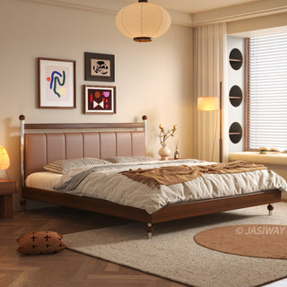 A serene, sunlit bedroom scene featuring a mid-century modern solid wood platform bed with a sleek, vertical-channel tufted leather headboard. The room is styled with herringbone wood floors, a cozy window nook with circular storage niches, abstract framed wall art, and warm ambient lighting from a large paper pendant lamp.