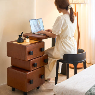JASIWAY mid-century modern solid wood vanity minimalist walnut finish makeup table with integrated three-drawer floating storage cabinet, featuring premium wood grain textures, rounded edges, and contemporary matte black hardware, ideal for high-end bedroom interior design.-Three-quarter view of model sitting