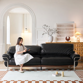 JASIWAY modern black top-grain leather sofa with adjustable headrests, luxury 3-seater couch featuring premium genuine leather upholstery, ergonomic cushioning, and sturdy wooden frame for a high-end living room aesthetic.-Front view with model sitting