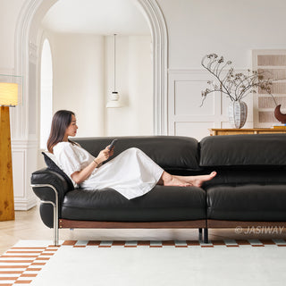 JASIWAY modern black top-grain leather sofa with adjustable headrests, luxury 3-seater couch featuring premium genuine leather upholstery, ergonomic cushioning, and sturdy wooden frame for a high-end living room aesthetic.-Front view with model leaning against the armrest