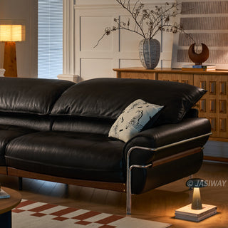 JASIWAY modern black top-grain leather sofa with adjustable headrests, luxury 3-seater couch featuring premium genuine leather upholstery, ergonomic cushioning, and sturdy wooden frame for a high-end living room aesthetic.-Medium shot with warm lighting