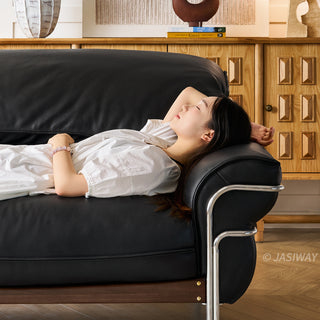 JASIWAY modern black top-grain leather sofa with adjustable headrests, luxury 3-seater couch featuring premium genuine leather upholstery, ergonomic cushioning, and sturdy wooden frame for a high-end living room aesthetic.-Close-up with model lying against the armrest