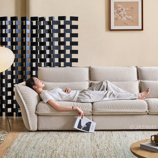 JASIWAY modern 3-seater fabric sofa with adjustable high-back headrests and deep-seated cloud cushions, featuring a low-profile minimalist design and ergonomic neck support with a high-end, contemporary aesthetic for luxury living rooms. -Front view with model laying down