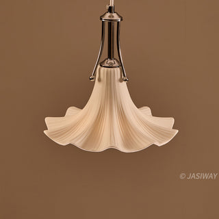 This pendant light features a graceful, trumpet-shaped ceramic shade with delicate, fluted ridges that evoke a refined botanical elegance. The creamy white finish is complemented by a sleek, polished chrome fixture, creating a harmonious balance between soft organic forms and structured metallic elements. Its minimalist yet sculptural design offers a quiet, editorial sophistication perfect for elevating a contemporary interior.