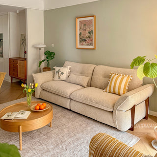 JASIWAY 3-seater fabric sofa featuring a low-profile Japandi silhouette with tufted back cushions and deep-seated upholstery, finished in a textured beige-toned linen-look bouclé fabric that emphasizes a minimalist yet sophisticated living room aesthetic.-Diagonal view