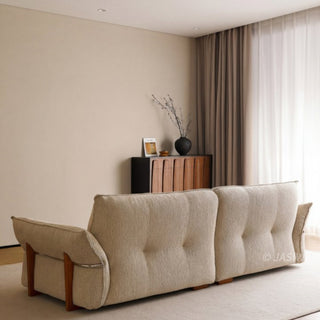 JASIWAY 3-seater fabric sofa featuring a low-profile Japandi silhouette with tufted back cushions and deep-seated upholstery, finished in a textured beige-toned linen-look bouclé fabric that emphasizes a minimalist yet sophisticated living room aesthetic.-Rear view