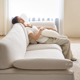 JASIWAY modern 3-seater sofa featuring a low-profile silhouette and a solid walnut-finished wood frame, upholstered in premium fabric or top grain leather, ideal for curated modern living room interiors.-Side medium shot with model leaning against the sofa