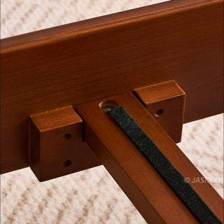 JASIWAY luxury minimalist platform bed with solid wood frame integrated with a curved chrome stainless steel tubular structure, featuring an ergonomic dual-pillow cushioned headboard upholstered in premium black leather, blending mid-century modern craftsmanship with industrial elegance, celebrated as the London Design Awards 2025 Silver Winner for master bedroom furniture design.-Close-up of the interior center beam joint