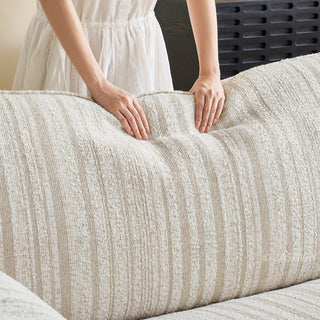 JASIWAY modern 3-seater sofa featuring a premium striped upholstery with deep-seated comfort, plush oversized cushions, flared armrests and solid wood legs in a dark walnut finish, showcasing a minimalist Japandi and organic modern aesthetic. -Close-up of cushion resilience