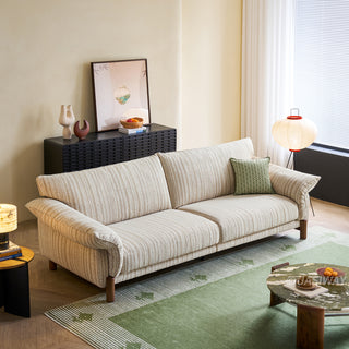 JASIWAY modern 3-seater sofa featuring a premium striped upholstery with deep-seated comfort, plush oversized cushions, flared armrests and solid wood legs in a dark walnut finish, showcasing a minimalist Japandi and organic modern aesthetic. -High-angle view