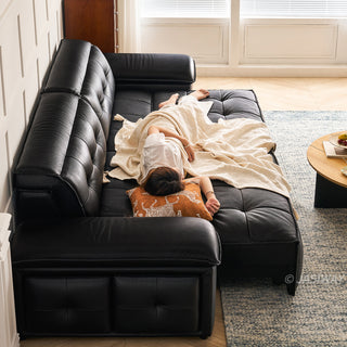 JASIWAY premium leather power reclining sleeper sofa featuring deep button-tufted backrests, adjustable panoramic headrests, and a unique open-concept recessed armrest with built-in storage, highlighting luxurious ergonomics, integrated technology, and space-saving functional furniture design for modern high-end homes.-Side vew with model lying